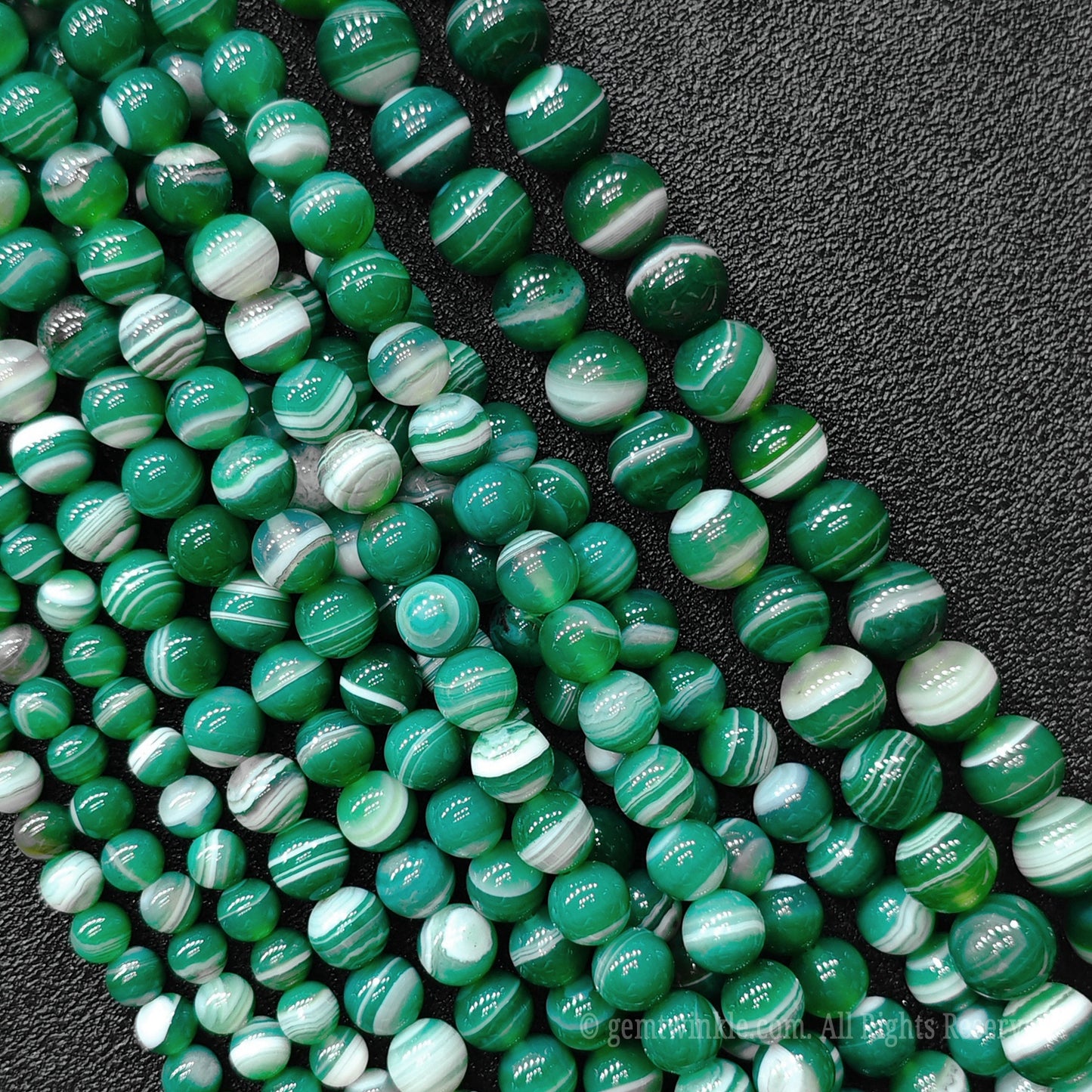Large batch collection of handpicked green striped agate round loose beads for commercial jewelry factories and high volume boutique sourcing