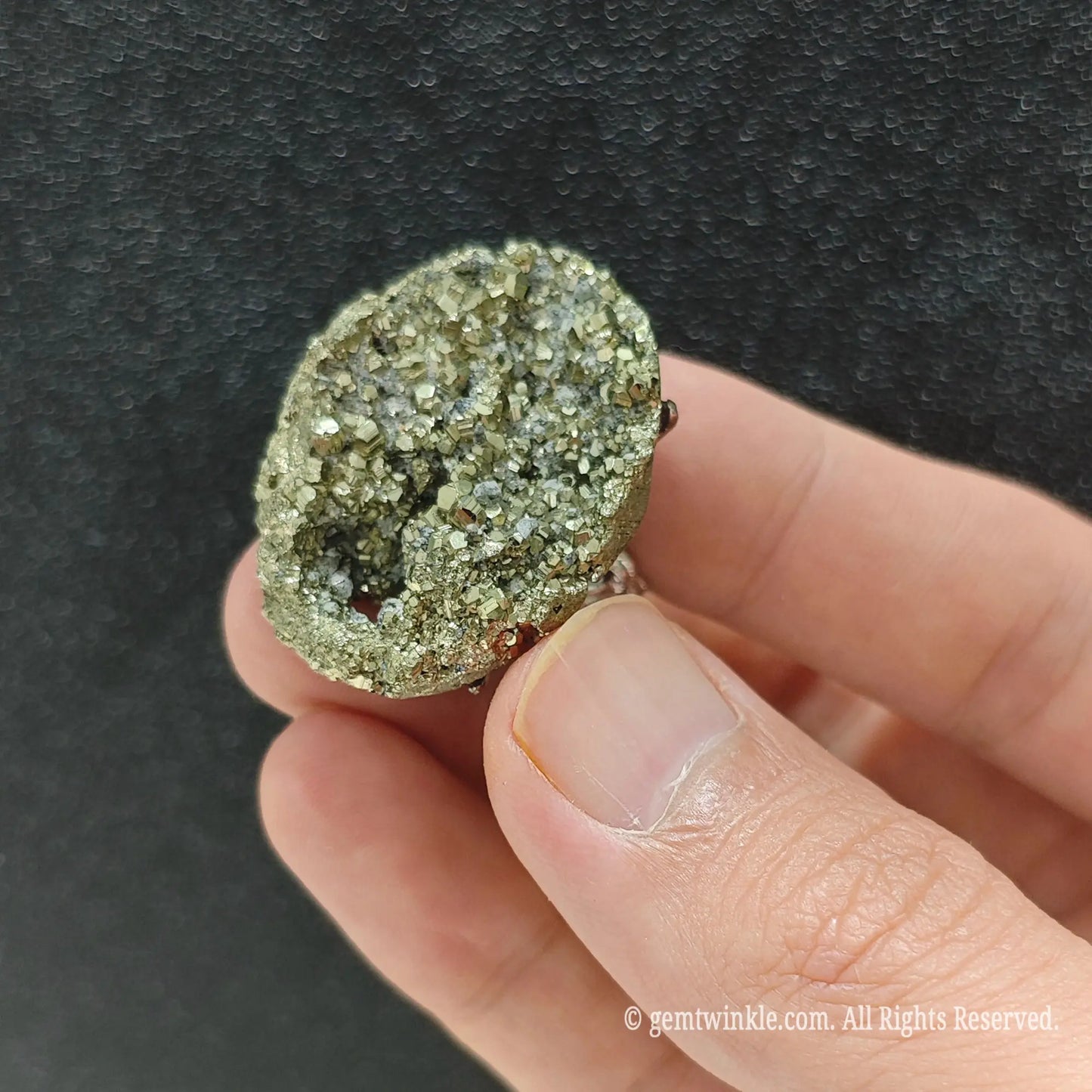 Metallic gold pyrite statement ring top view on finger displaying 25-35mm raw mineral cluster formation
