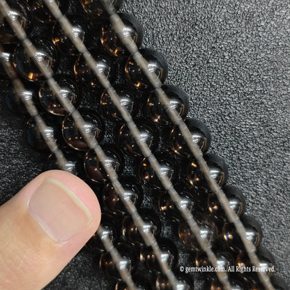 Close up of tiny natural micro 2mm and 3mm ice obsidian beads ideal for dainty minimalist jewelry making