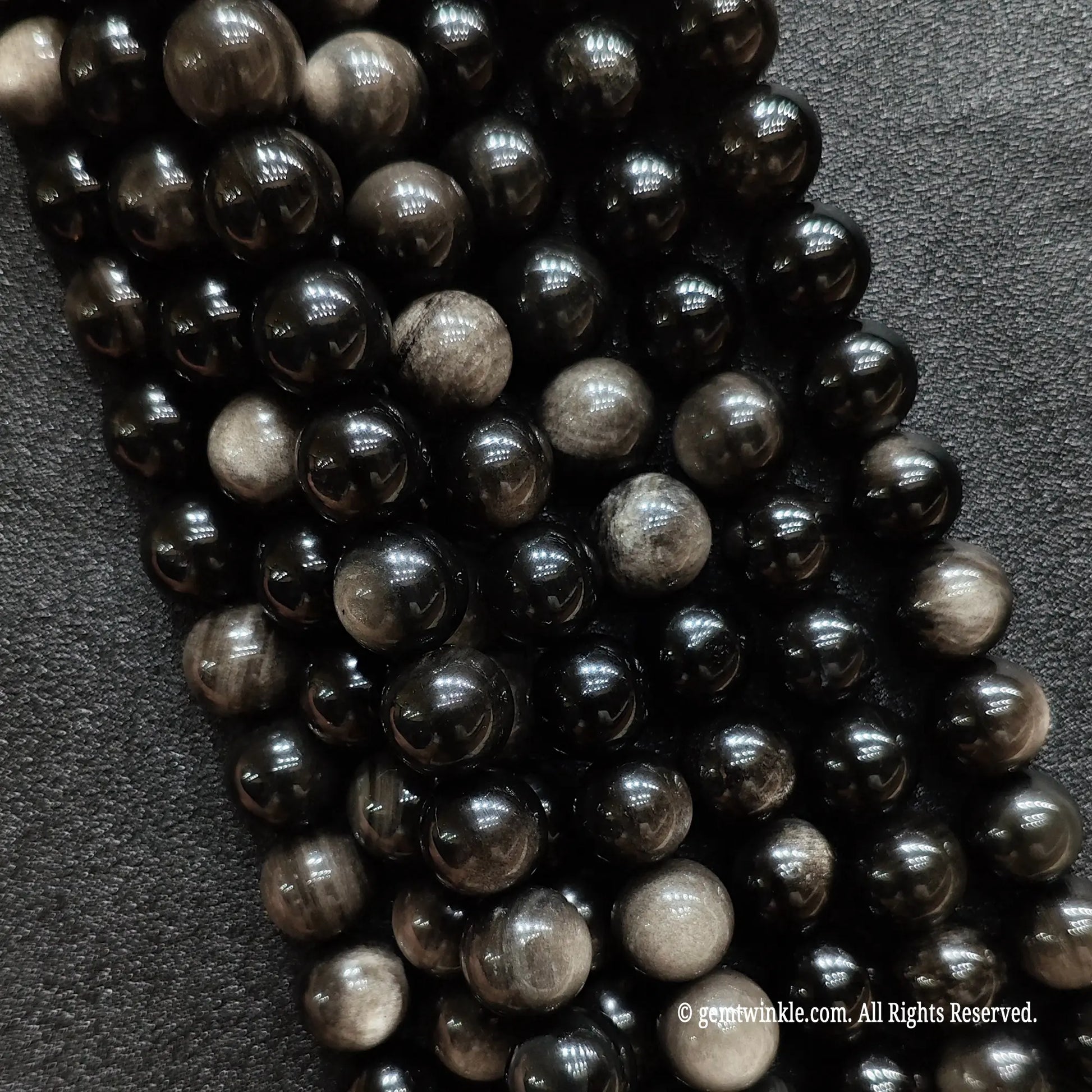 Close up of natural micro 2mm silver sheen obsidian beads ideal for dainty minimalist jewelry making