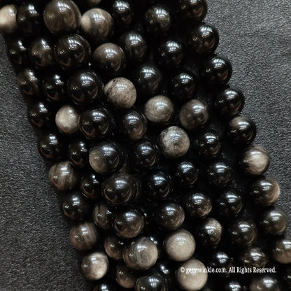 Close up of natural micro 2mm silver sheen obsidian beads ideal for dainty minimalist jewelry making