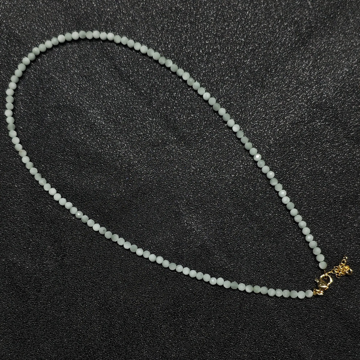 Milky mint green angelite gemstone collar necklace featuring 3mm opaque faceted beads and gold extension chain