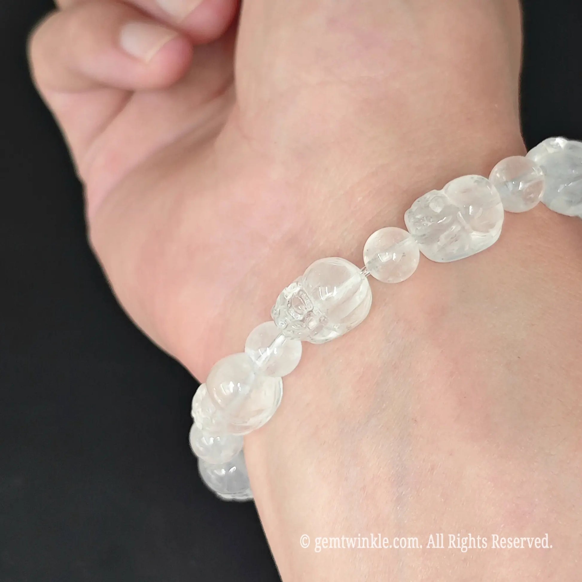 side view of natural misty cloudy quartz pixiu bead stretch bracelet on wrist