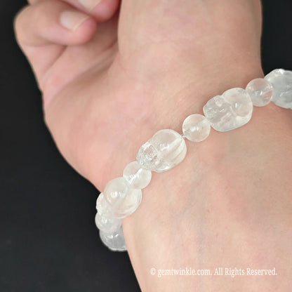 side view of natural misty cloudy quartz pixiu bead stretch bracelet on wrist