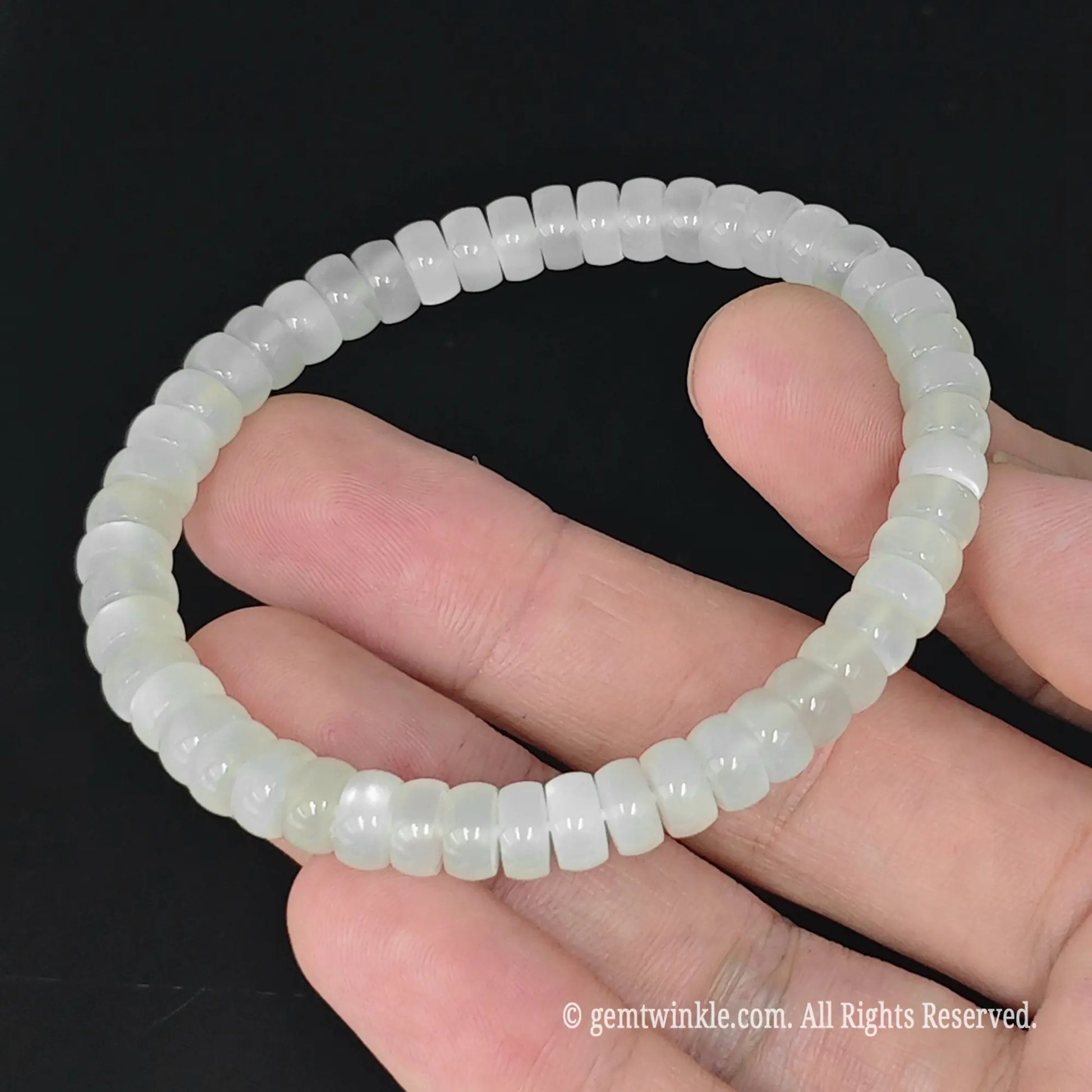top view of 6mm milky white moonstone wheel shaped bead stretch bracelet 17cm