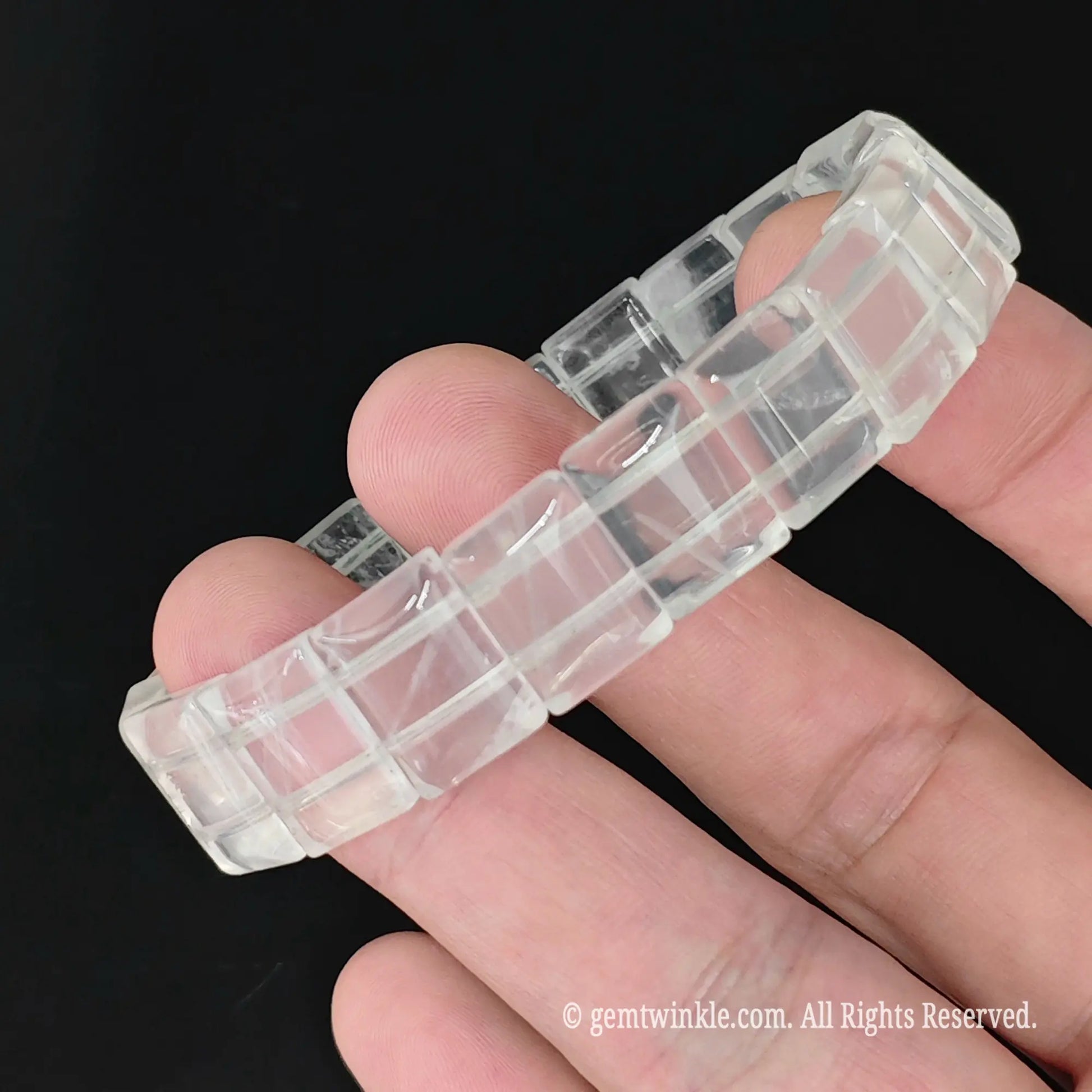 milky white crystal smooth rectangular bead bracelet held horizontally