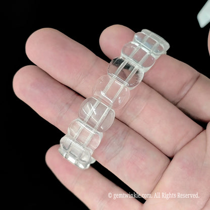 Milky white crystal smooth rectangular bead bracelet held vertically displaying glossy rounded rectangular beads
