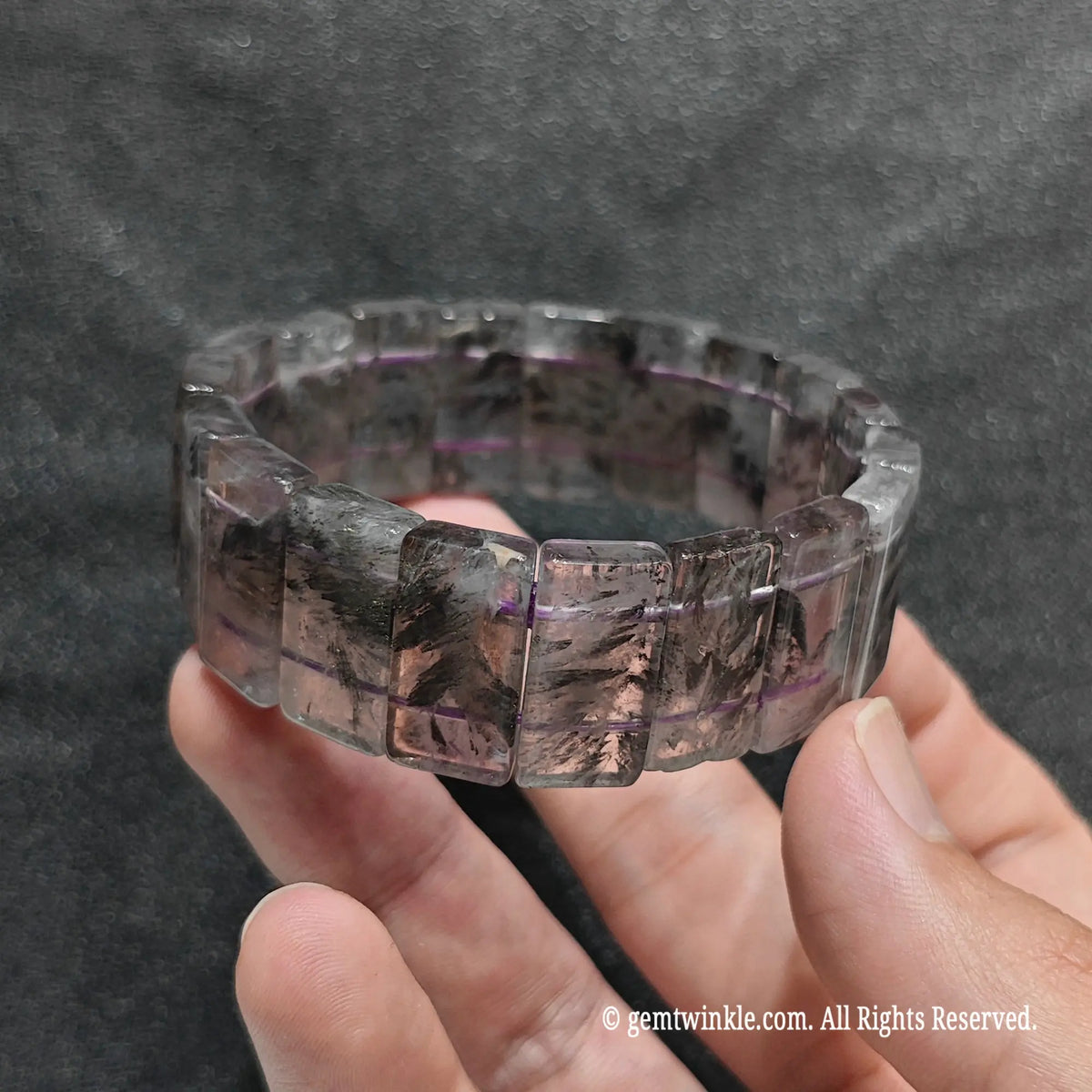 Side view of a minimalist auralite 23 rectangle stretch wristlet displaying raw mineral inclusions inside purple quartz[cite: 6]