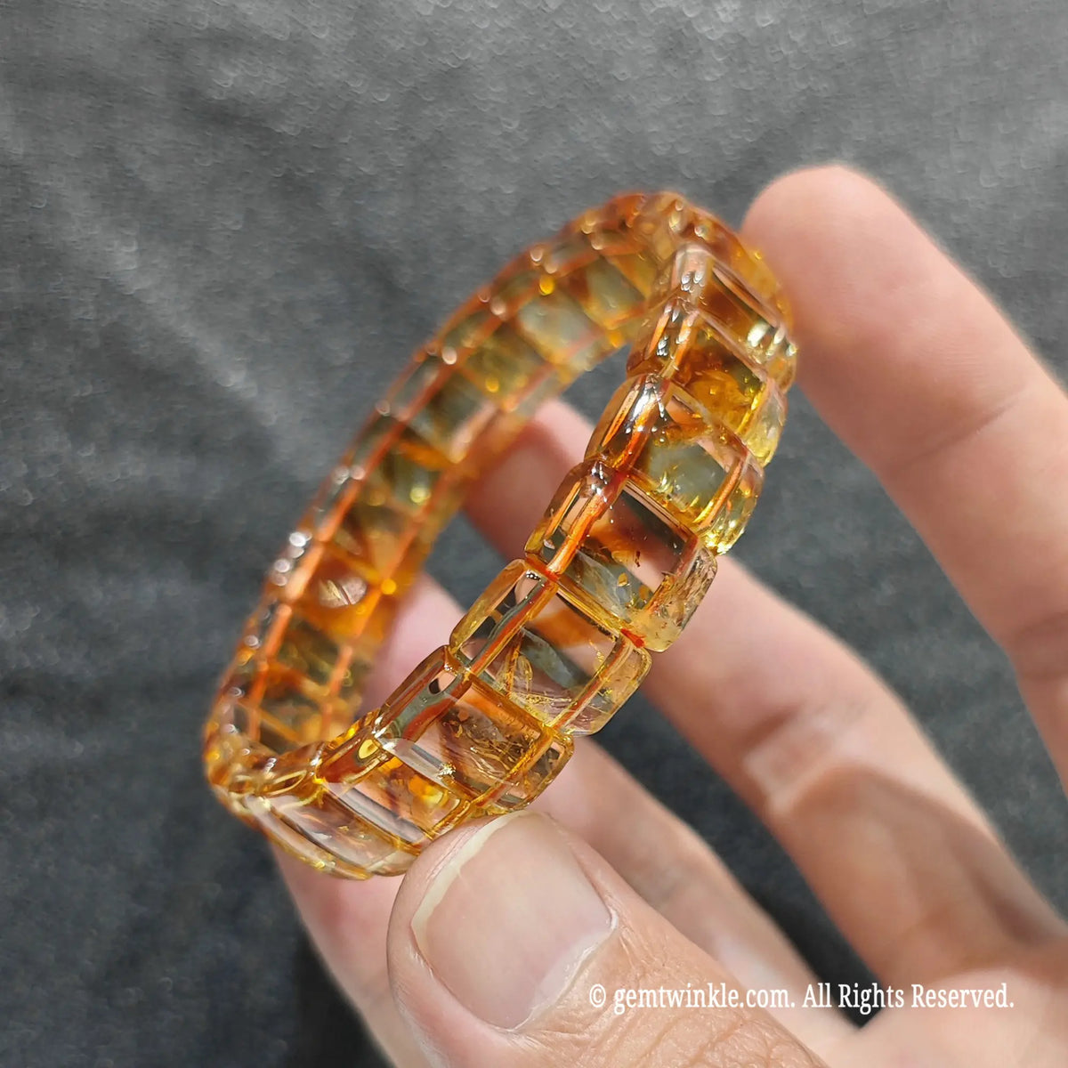 Perspective shot of a minimalist honey citrine flat bead strand highlighting internal tower phantom structures