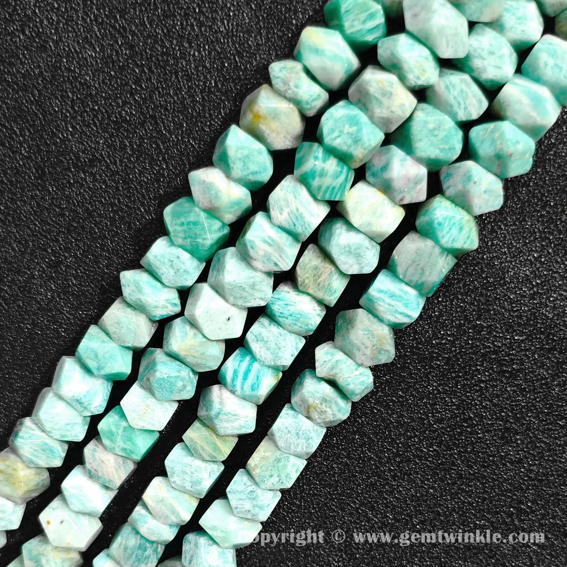 Close up view of mint green amazonite tube cylinder beads showing white veining