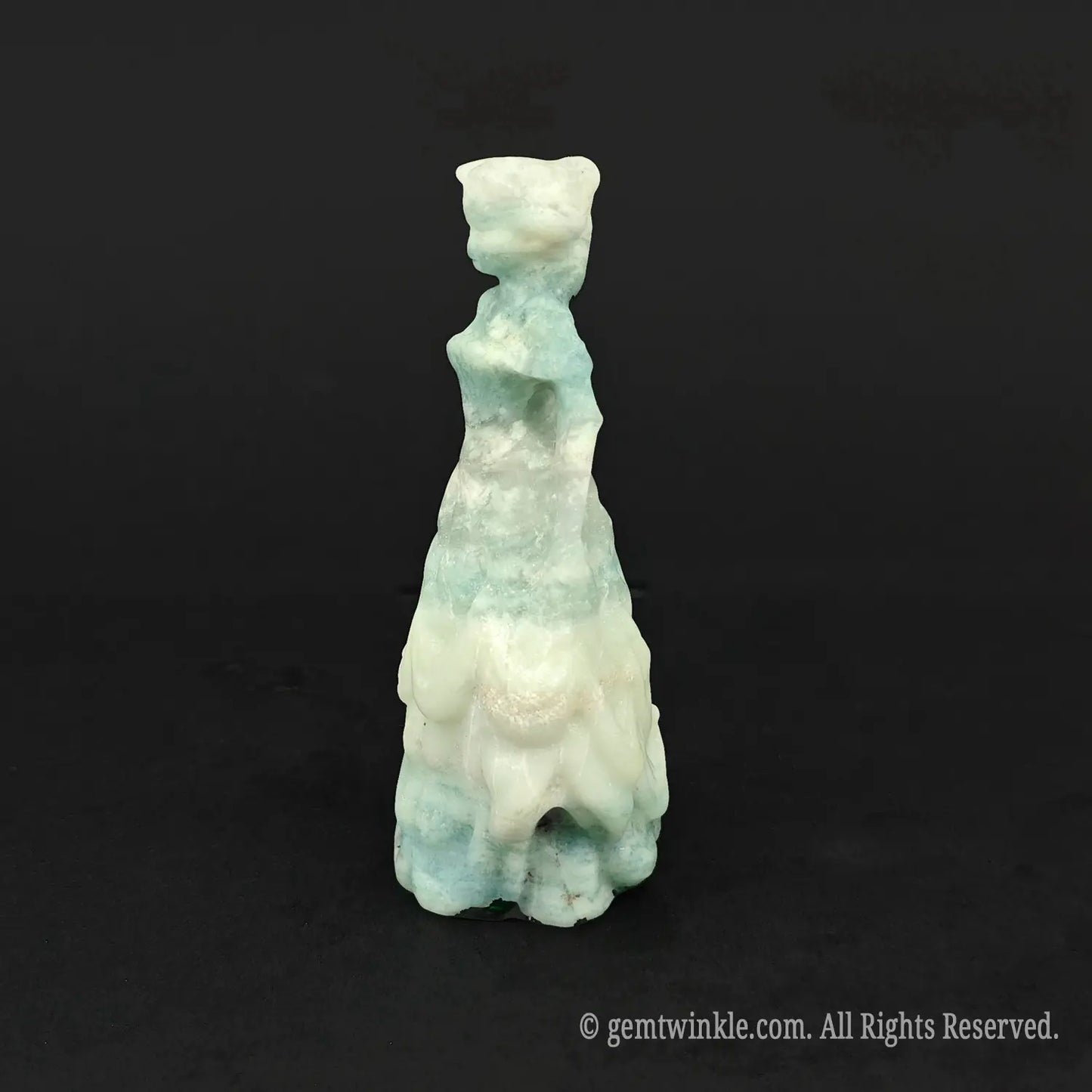 Side view of a hand-carved natural mint silk gemstone princess figurine, showcasing the structured waist and flowing skirt layers