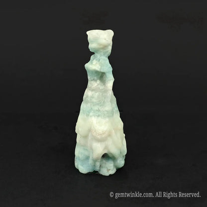 Side view of a hand-carved natural mint silk gemstone princess figurine, showcasing the structured waist and flowing skirt layers