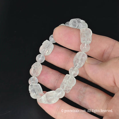 misty semi translucent quartz pixiu bead strand laid flat across fingers