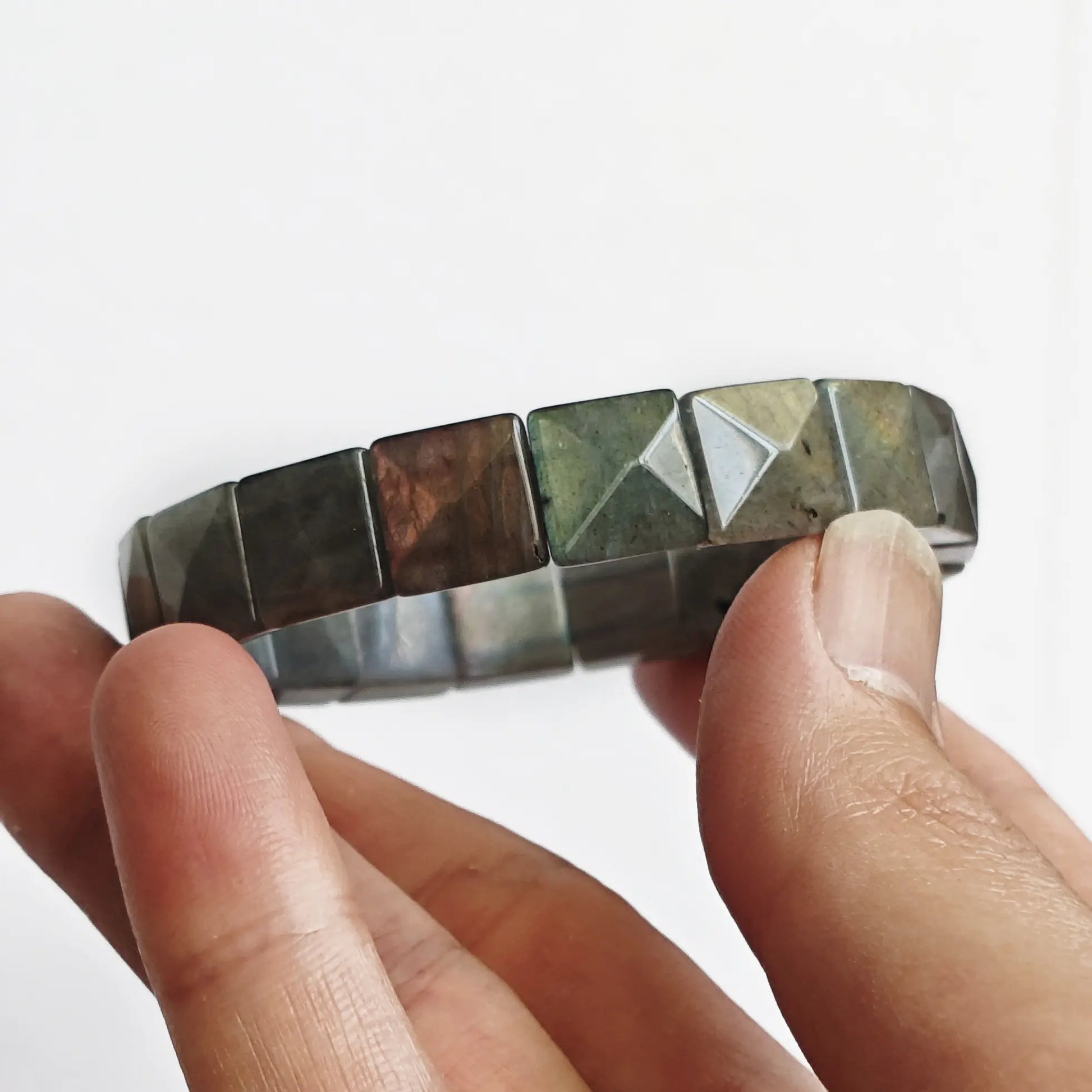 Flexible stretch band moonstone bracelet being gently bent to show elasticity and bead alignment