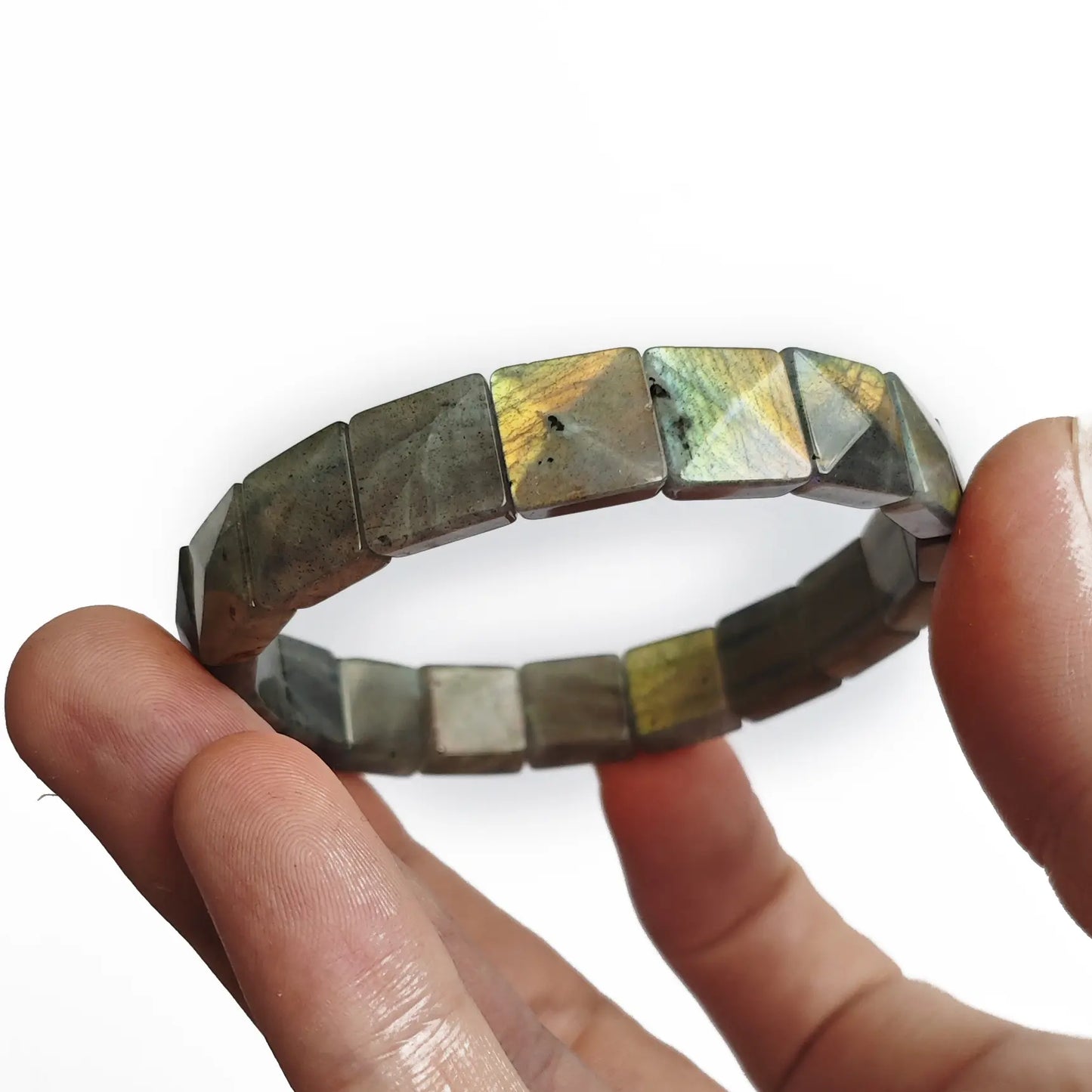 Hand holding moonstone bracelet to emphasize size scale and natural stone texture
