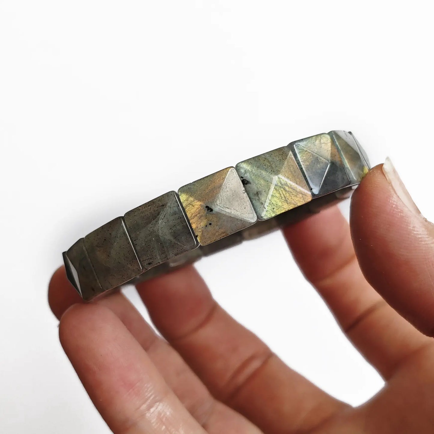 Top-down view of moonstone bracelet highlighting symmetrical faceting and polished surfaces