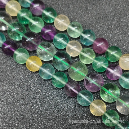Multiple strands of multi-color rainbow fluorite loose gemstone beads with colorful green yellow and purple bands directly from Donghai crystal market