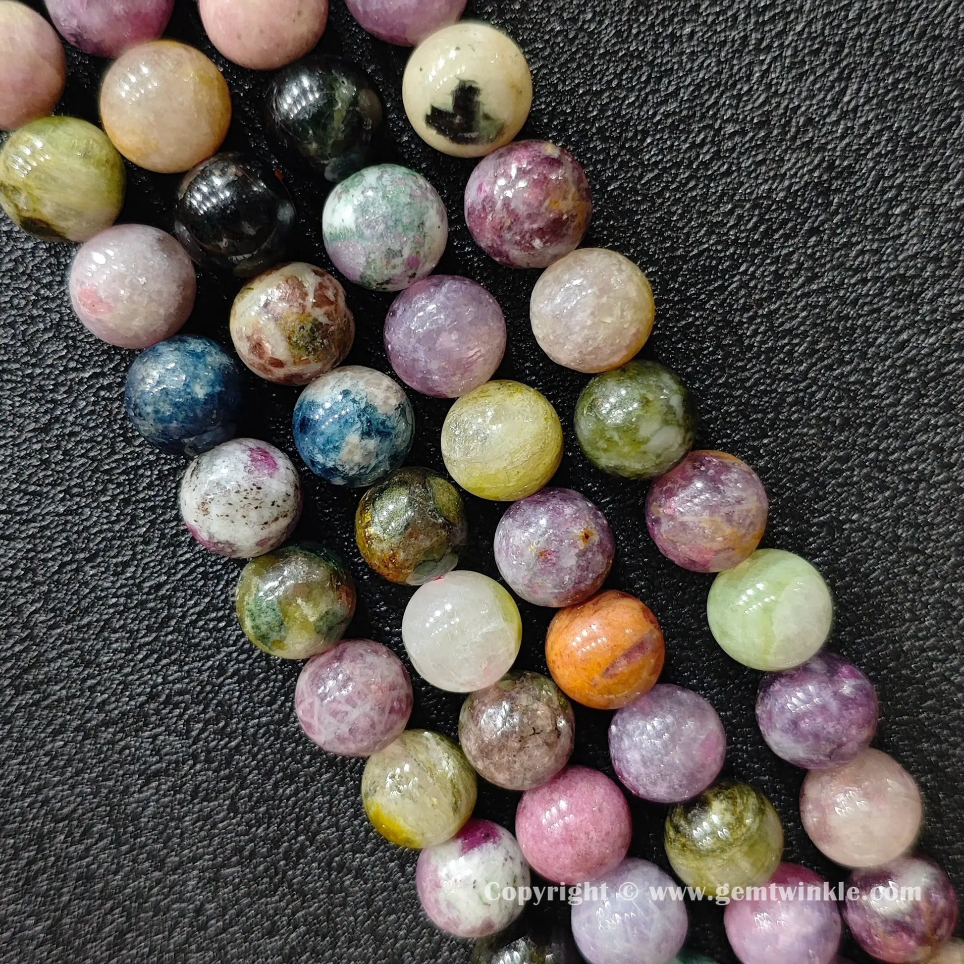 multi-color-tourmaline-beads-finger-scale-view