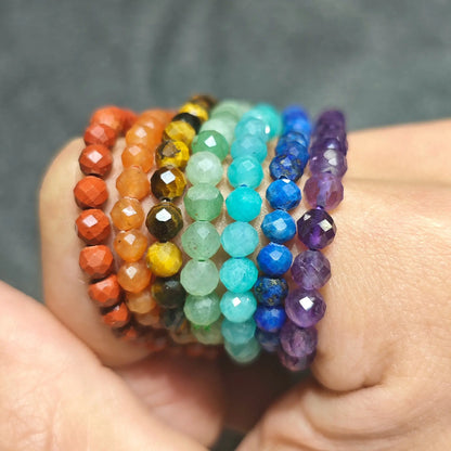 detailed close up view of 7 individual natural gemstone faceted bead bracelets showing red jasper tiger eye lapis amethyst beads