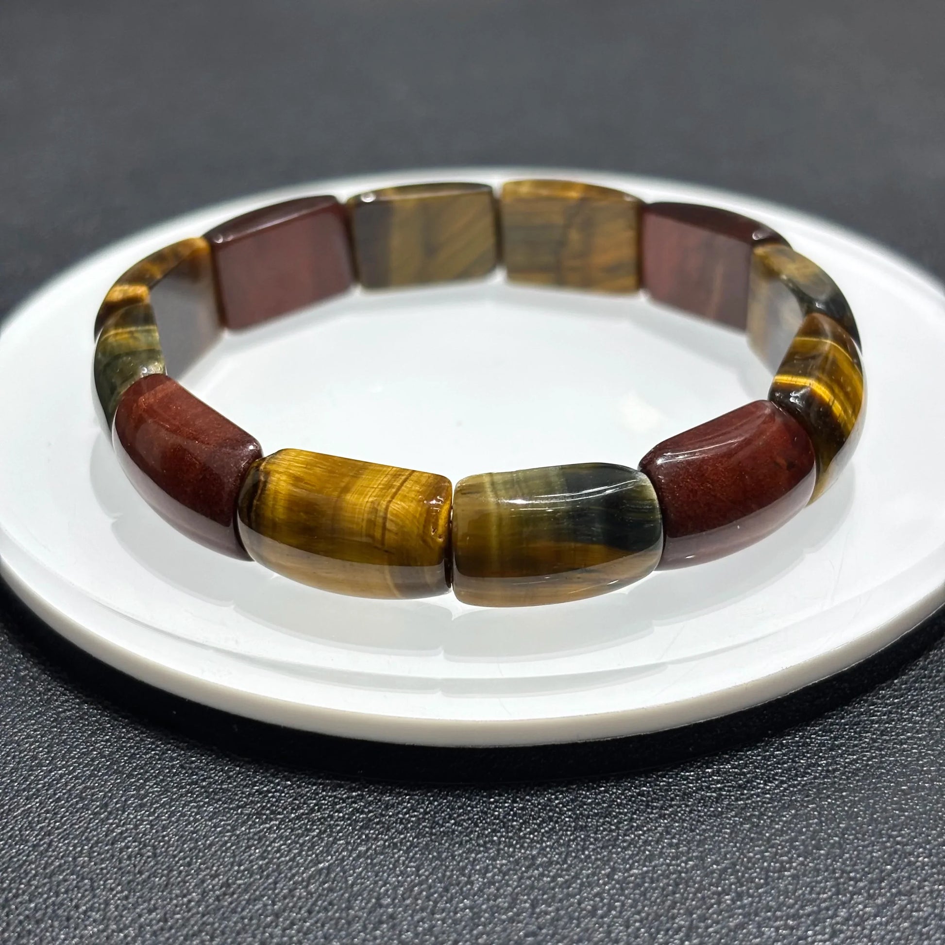 Multicolor Tiger Eye Bangle displayed on a white stand, showing the full 17cm circumference and stretchy elastic cord.