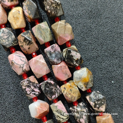 multiple strands of faceted black veined rhodonite barrel beads