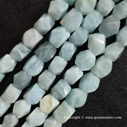multiple strands of faceted blue beryl aquamarine beads held in hand