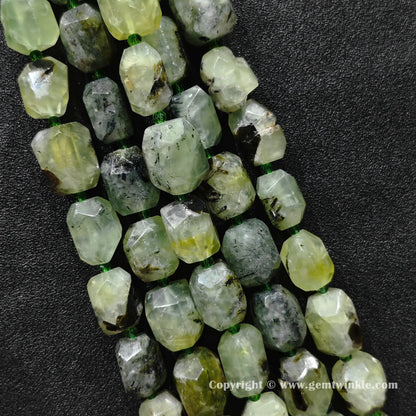 multiple strands of large chunky prehnite faceted barrel beads on dark display