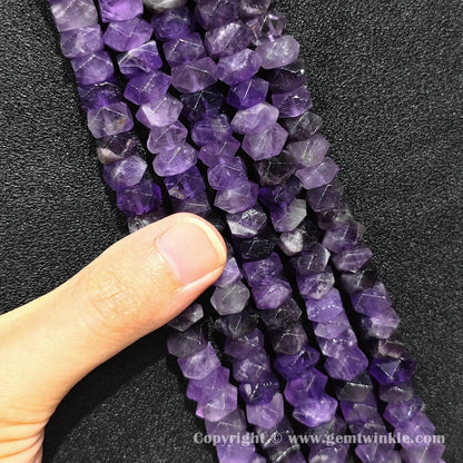 Hand holding 35cm strand of natural amethyst 10x6mm faceted column beads