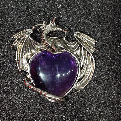 Antique pewter-tone metal alloy dragon wrapped around natural amethyst heart showing dense ice inclusions