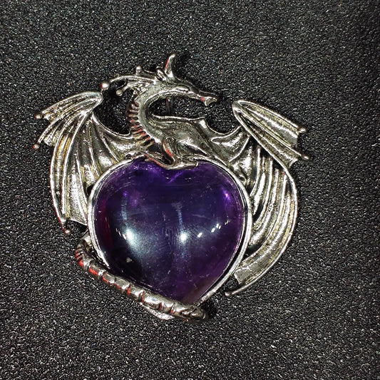Antique pewter-tone metal alloy dragon wrapped around natural amethyst heart showing dense ice inclusions