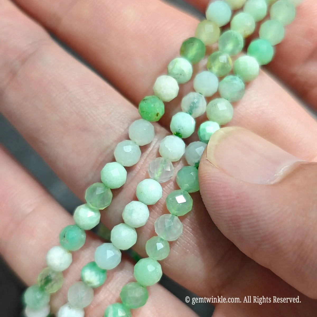 Trio of natural Australian green chalcedony faceted bead bracelets stacked on hand showing bright apple green translucency