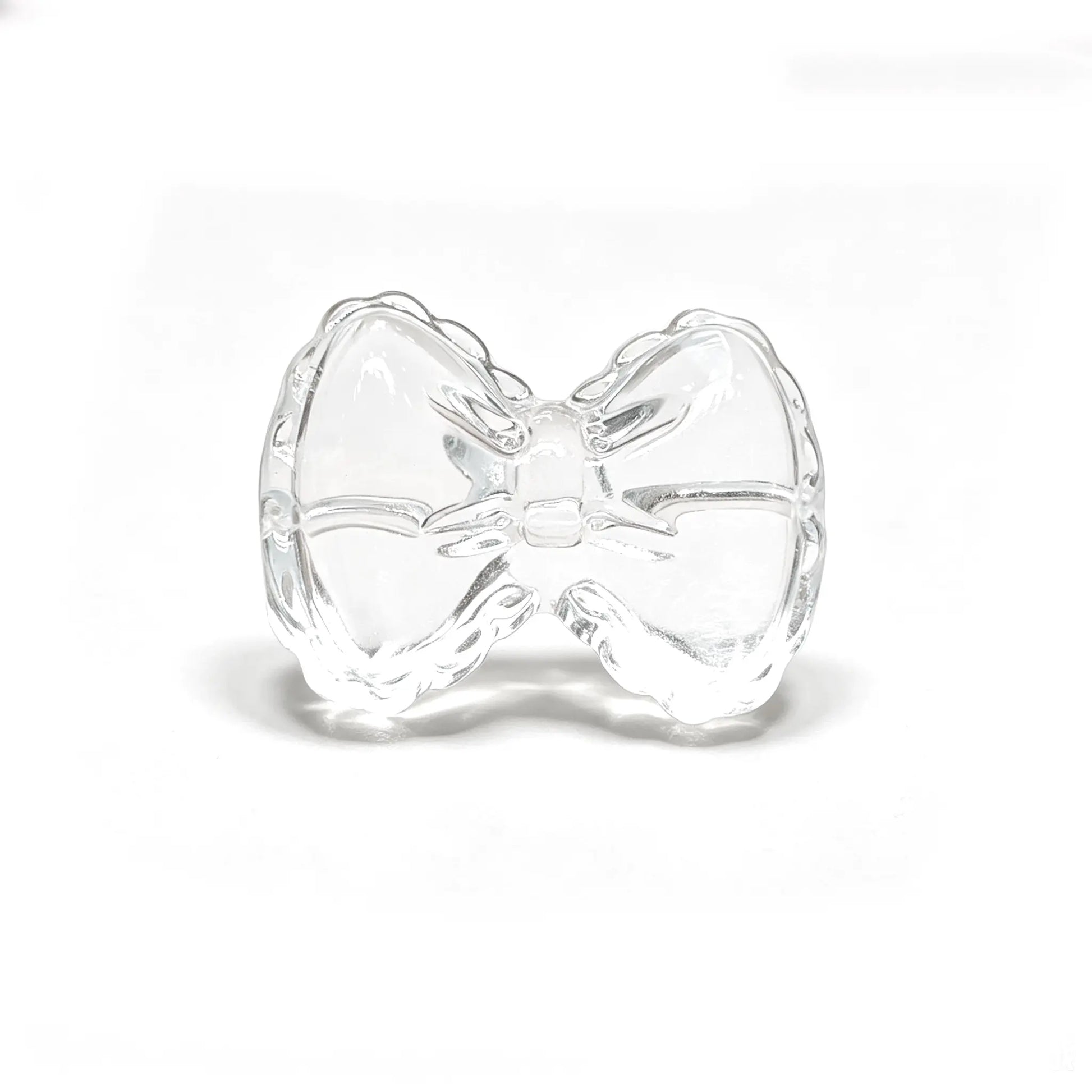 Natural clear quartz bowknot carving bead with horizontal hole on isolated white background for jewelry design