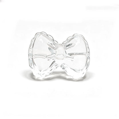 Natural clear quartz bowknot carving bead with horizontal hole on isolated white background for jewelry design