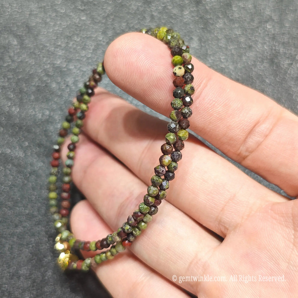Detailed macro view of 3mm micro faceted Dragon Blood Jasper beads showing vivid crimson and forest green textures