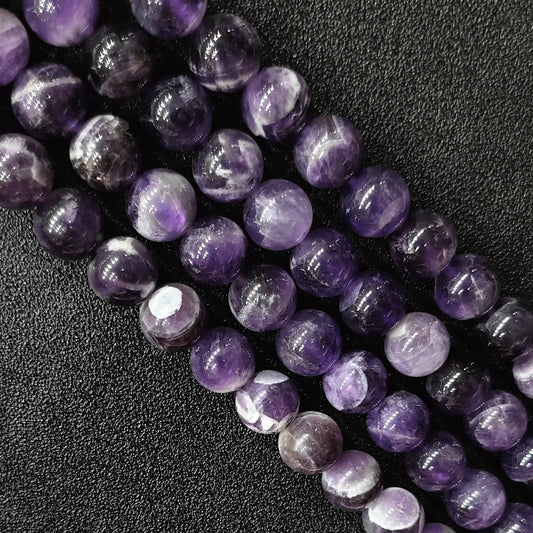 Macro detailed shot of natural dream amethyst loose round beads fresh batch with vivid contrast and zero yellowing tint