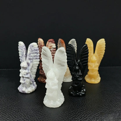 A collection of hand carved natural earth stone guardian angel statues in black obsidian pink opal flame stone and zebra stone
