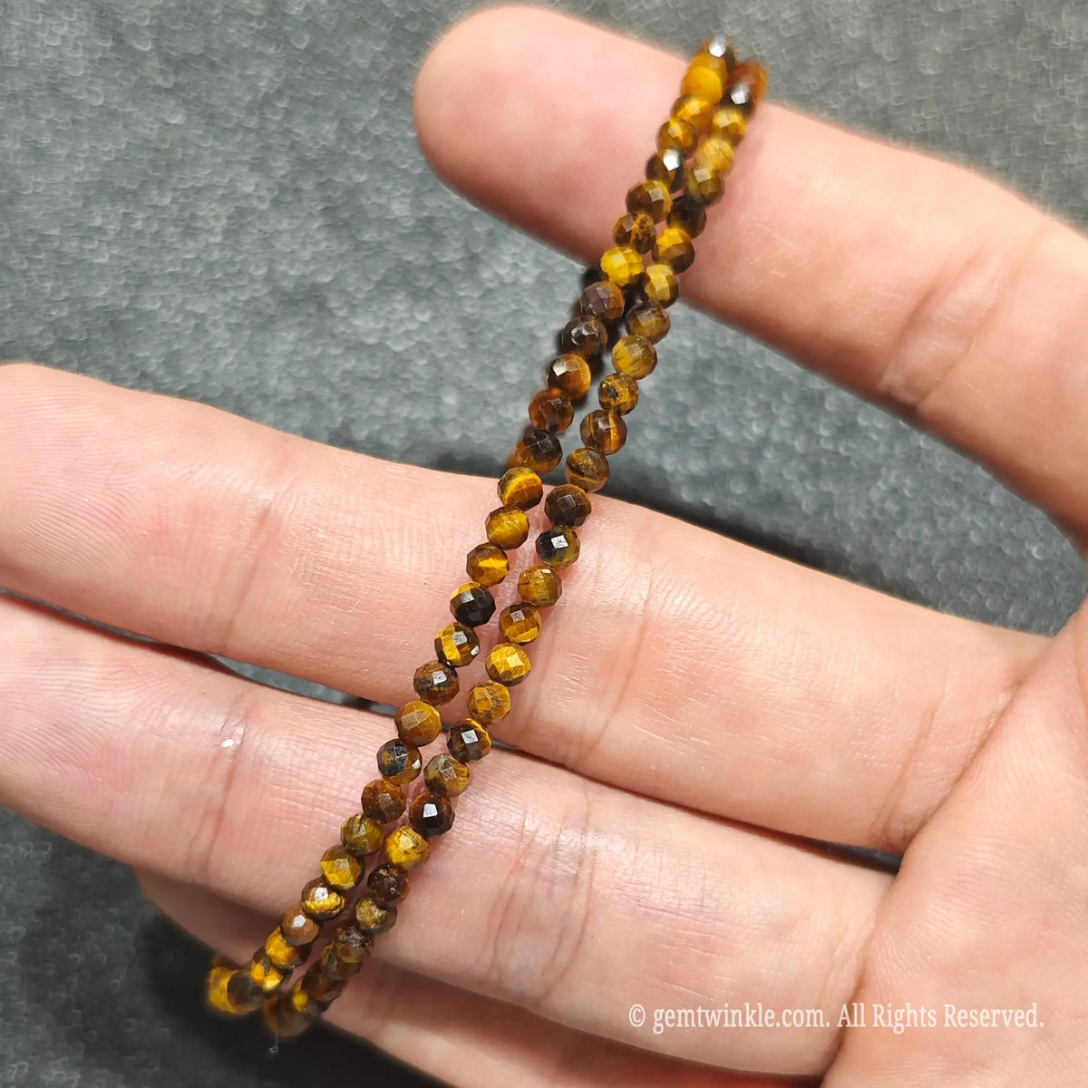 Detailed macro view of 3mm micro faceted Golden Tiger Eye beads showing warm amber and brown chatoyant luster