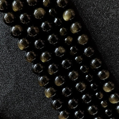Grade A natural gold sheen obsidian round beads showing golden chatoyancy