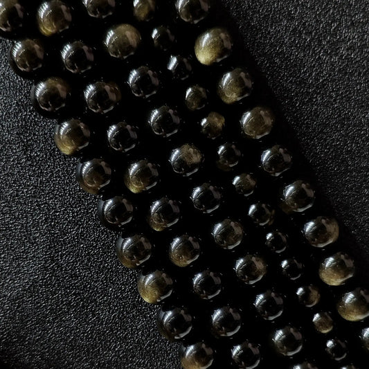 Grade A natural gold sheen obsidian round beads showing golden chatoyancy