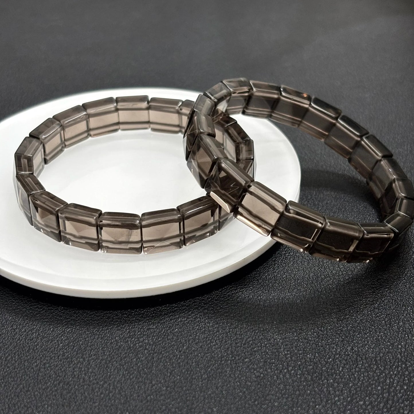 Side view of two Gem's Twinkle icy obsidian bangles highlighting the 12x10mm rectangular bead shape.