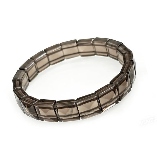 Close-up of natural icy obsidian rectangular bead bracelet, showcasing smooth faceted texture and translucent smoky color, Gem's Twinkle brand.