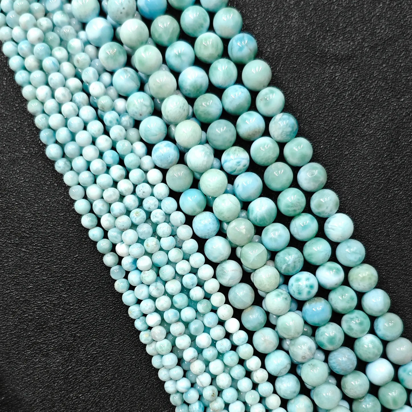 Natural larimar crystal beads grade b plus showing beautiful blue wave patterns in small strands