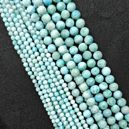 Natural larimar crystal beads grade b plus showing beautiful blue wave patterns in small strands