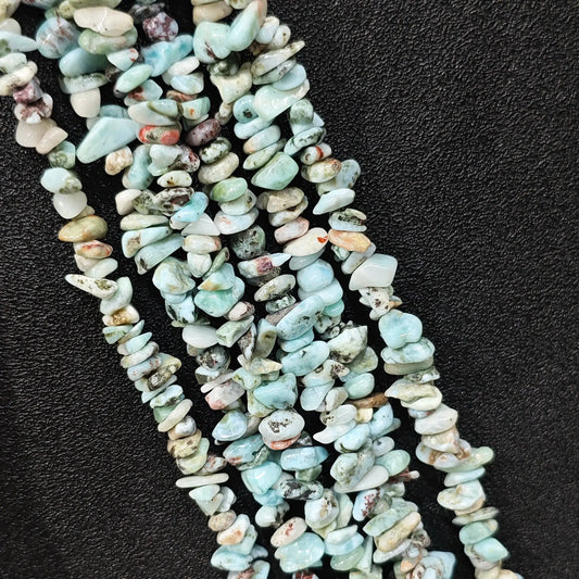 Strand of natural blue larimar freeform chip beads with host rock matrix inclusions