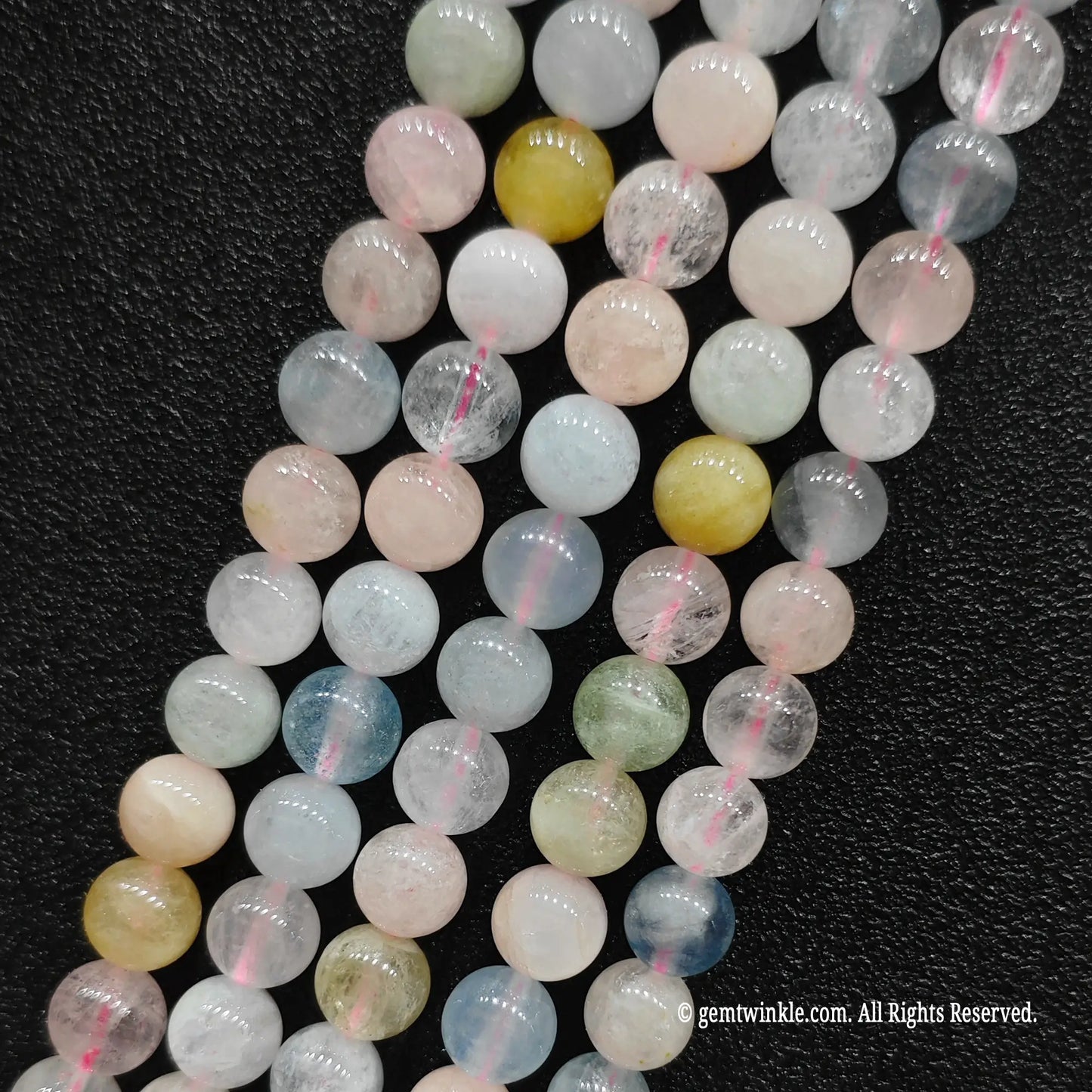 Parallel wholesale strands of natural mixed beryl commercial morganite crystal beads featuring premium B plus grade transparency