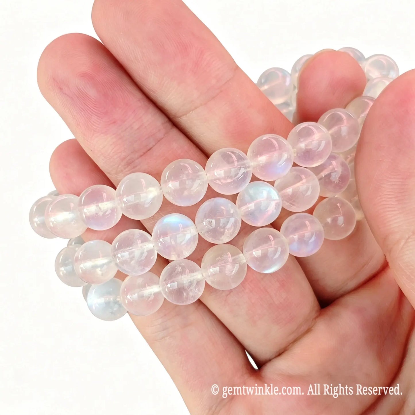Close up preview of single-strand moonstone beads highlighting smooth spherical polish