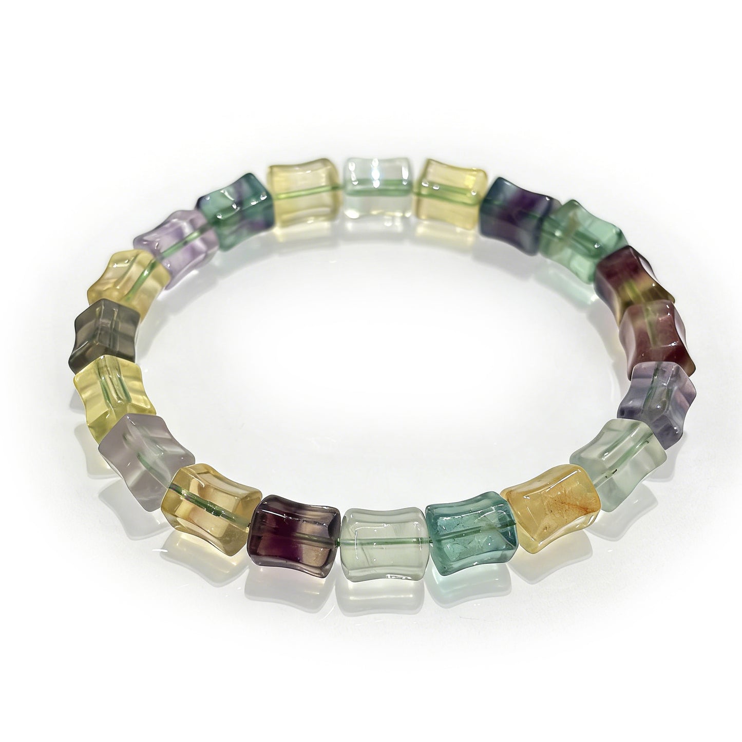A high-quality natural multicolor fluorite bamboo bracelet featuring green, purple, and yellow stones on an elastic band, perfect for stackable jewelry.
