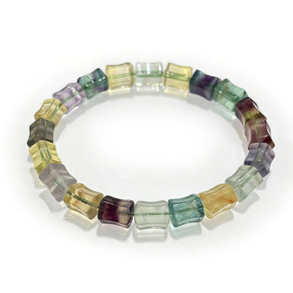 A high-quality natural multicolor fluorite bamboo bracelet featuring green, purple, and yellow stones on an elastic band, perfect for stackable jewelry.