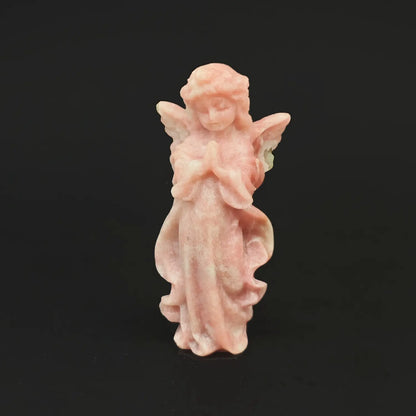 A 10cm hand-carved natural pink opal praying guardian angel figurine with fine wings on a dark background, perfect for romantic anniversary gifts
