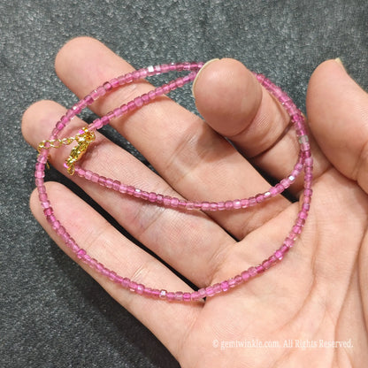 Detailed macro view of 2.5mm square cube Pink Tourmaline beads showing translucent rose pink gemstones